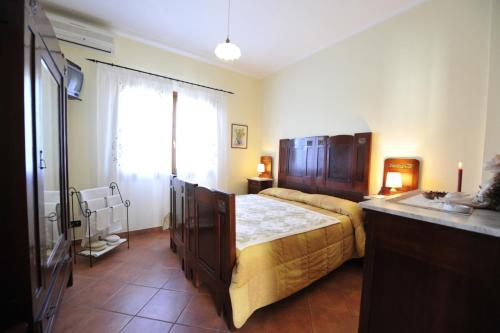 een slaapkamer met een groot bed en een wastafel bij B&B Ca' de Pippu in Diano Castello