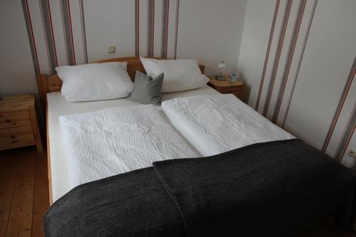 a bedroom with two beds with white sheets and pillows at Ferienwohnung Meuser in Traben-Trarbach