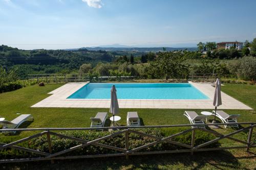 a villa with a swimming pool and lawn at Borgo Amarrante in Montaione