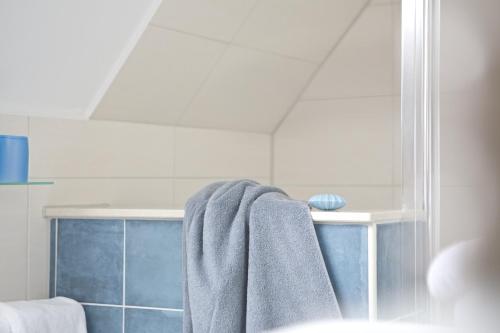 a towel hanging on a towel rack in a bathroom at Hotel Jess am Meer in Büsum