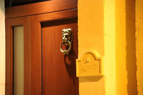 a wooden door with a clock on it at Palazzo Savoia 1856 in Fasano