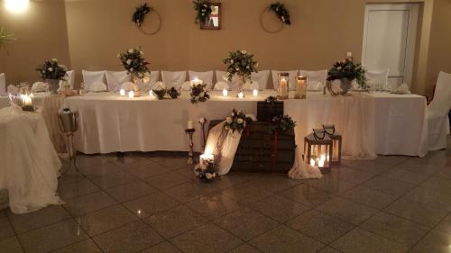 a room with white tables with candles and flowers at Sunrise Resort Hotel in Mithymna