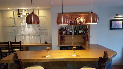 een restaurant met een tafel met twee glazen wijn bij Castle Limes Hotel in Warwick