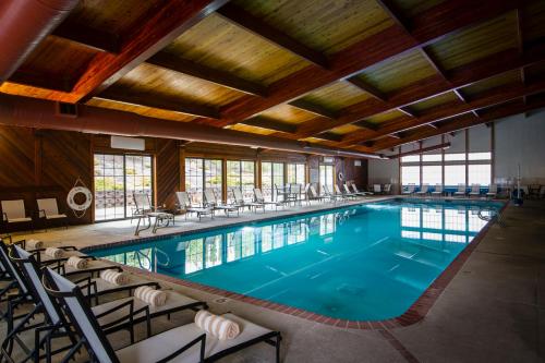 a large swimming pool with chairs and tables in a building at Stoneridge Resort in Blanchard