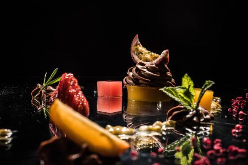 a dessert with chocolate and fruit on a table at Linder Cycling Hotel in Selva di Val Gardena