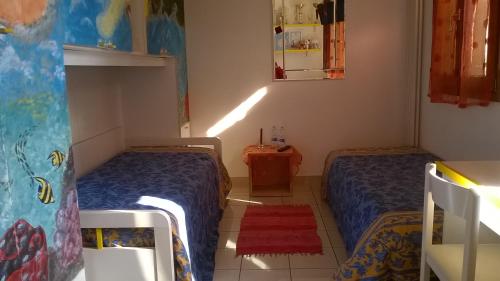 a small bedroom with two beds and a mirror at La Luce della Luna in Castelnovo Bariano