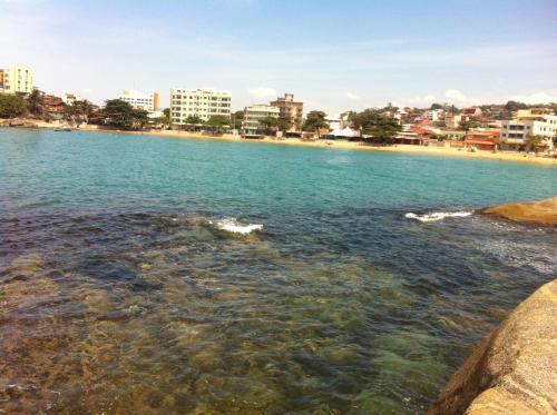 a view of a beach with a city in the background at Pousada Recanto da Pedra in Iriri