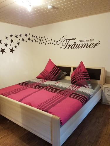 a bedroom with a bed with stars on the wall at Ferienhaus Waldblick in Sangerhausen