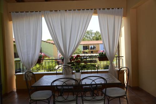 a table and chairs in a room with a balcony at I Giardini Elisei in Policoro