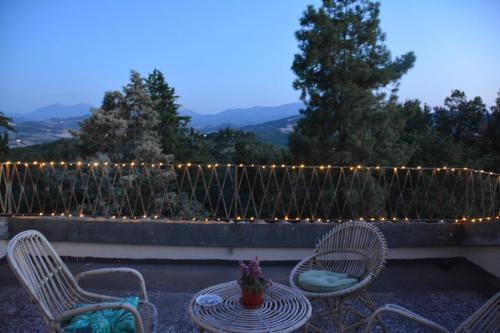 a patio with a table and chairs and lights at Ca'Lavalle B&B in Urbino