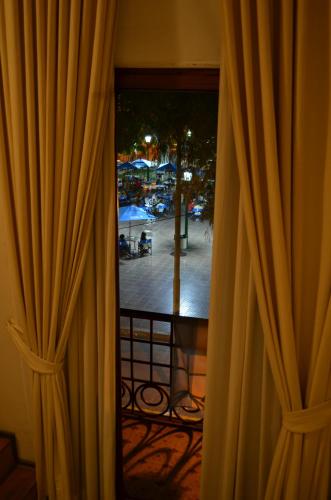 a window with curtains and a view of a patio at Telmho Hotel Boutique in Buenos Aires