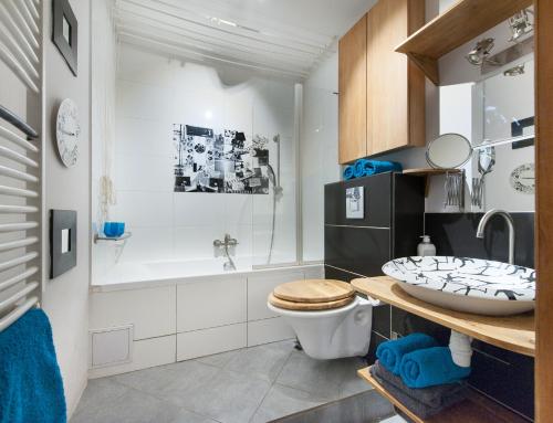 łazienka z toaletą, umywalką i wanną w obiekcie Apartament Dobre Miejsce w Olsztynie