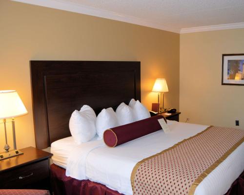 a hotel room with a bed with a briefcase on it at Best Western Plus Wilkes Barre Center City in Wilkes-Barre
