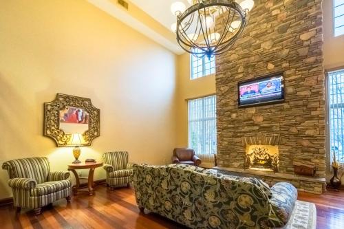 a living room with a couch and a stone wall at The Wildwood Hotel in Wildwood