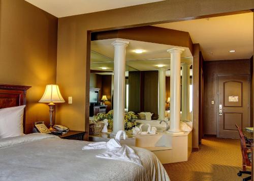 a bedroom with a bed and a large mirror at The Wildwood Hotel in Wildwood
