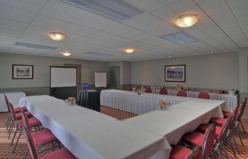 a conference room with tables and chairs and a screen at Best Western The Westerly Hotel in Courtenay