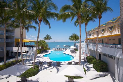 a view of a resort with a swimming pool and palm trees at Best Western On The Bay Inn & Marina in Miami Beach