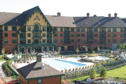 a large hotel with a large swimming pool at The Appalachian at Mountain Creek in Vernon