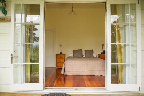 an open door to a bedroom with a bed at Margrain Vineyard Villas in Martinborough 