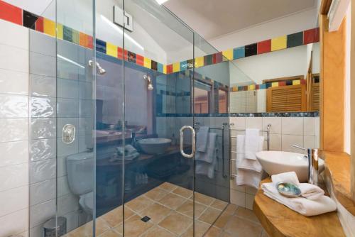 La salle de bains est pourvue d'une douche en verre et d'un lavabo. dans l'établissement Crab Cove, à Mahinepua