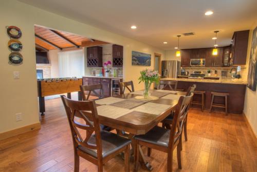 a kitchen and dining room with a wooden table and chairs at Prestigious Home South Lake Tahoe in South Lake Tahoe