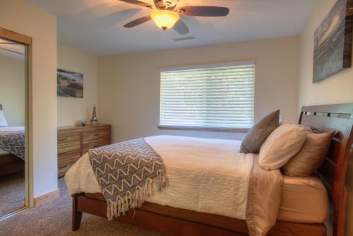 a bedroom with a bed and a ceiling fan at Prestigious Home South Lake Tahoe in South Lake Tahoe