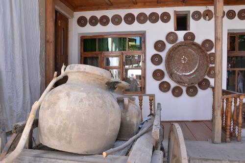 a room with a bunch of pots and plates on the wall at Hotel Legende in Samarkand