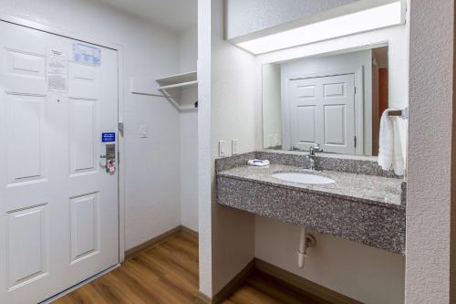 a bathroom with a sink and a mirror at Motel 6-Hutchins, TX in Hutchins