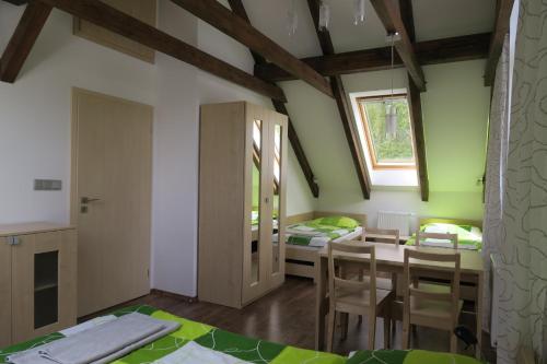 a kitchen and dining room with a table and chairs at Penzion Na Pohoři in Olešnice