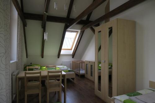 a room with a table and chairs and a window at Penzion Na Pohoři in Olešnice