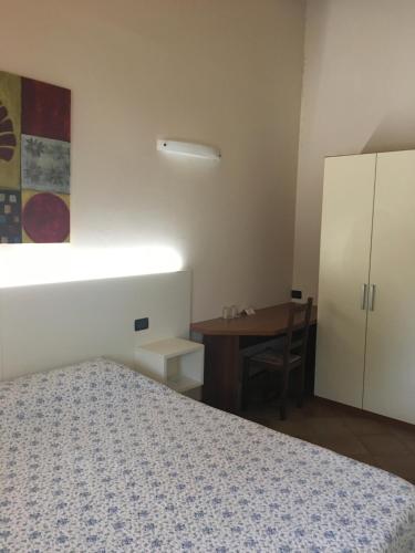 a bedroom with a bed and a desk and a table at Villa Pasini in Provaglio d'Iseo