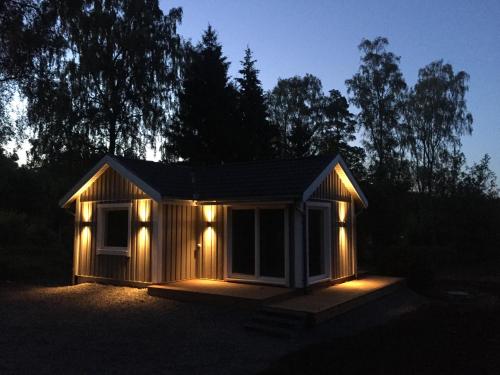 a small cabin with lights in the dark at Landvetter House in Landvetter