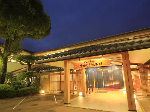 a building with a sign on the front of it at Shimoda Central Hotel in Shimoda