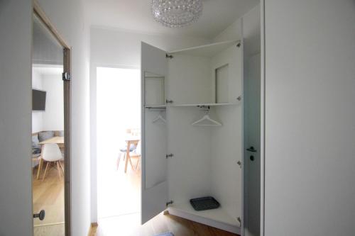 a room with a closet with a door and a mirror at Apartment Bergjuwel in Sonnenalpe Nassfeld