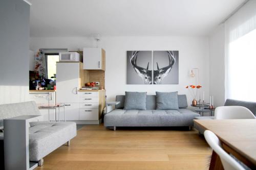 a living room with a couch and a table at Apartment Bergjuwel in Sonnenalpe Nassfeld