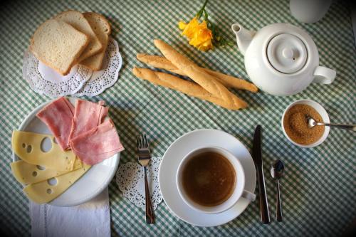 a table with a plate of food and a cup of coffee at B&B Antica Biblioteca in Fermo