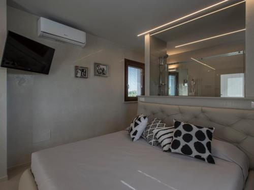 a bedroom with a bed with a mirror on the wall at Osteria dei Segreti in Appignano