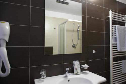 a bathroom with a sink and a mirror at Residence Hotel Anna in Passo del Tonale