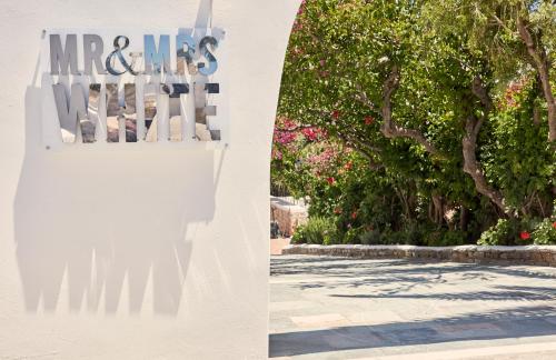 a white fence with a tree in the background at Mr and Mrs White Paros in Naousa
