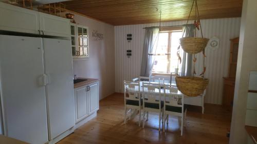 a kitchen with a table and chairs and a window at Torp Källtorp B&B in Kisa