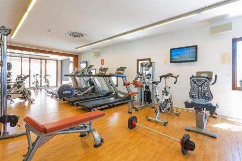 a gym with several treadmills and exercise machines at Grand Palladium Select Palace Ibiza - All Inclusive in Playa d'en Bossa