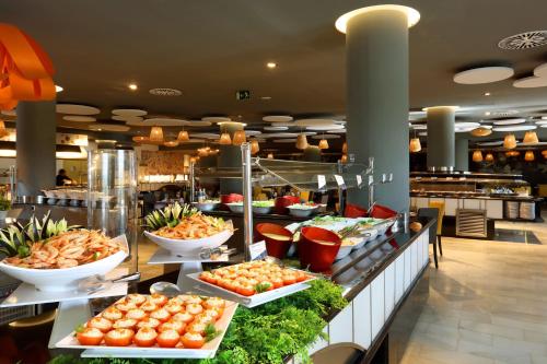 a buffet table filled with lots of different types of food at Grand Palladium White Island Resort & Spa - All Inclusive in Playa d'en Bossa