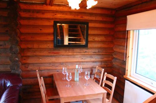 a dining room with a table in a log cabin at Akureyri Log Cottage in Akureyri