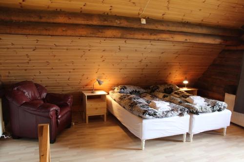 a room with a bed in a wooden wall at Akureyri Log Cottage in Akureyri