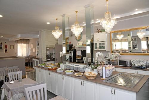 a kitchen with a counter with food on it at Hotel Al Ragno in Cesenatico