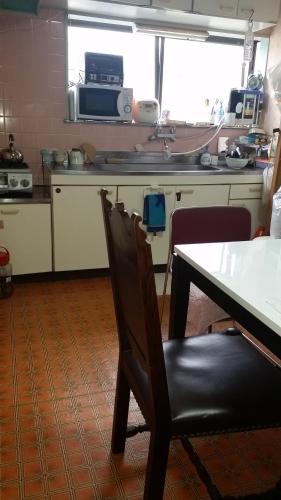 a kitchen with a table and a table and a chair at "Cherry House" is Direct to Narita,Haneda AP, Disney, Asakusa, Skytree Tower, Tokyo in Matsudo