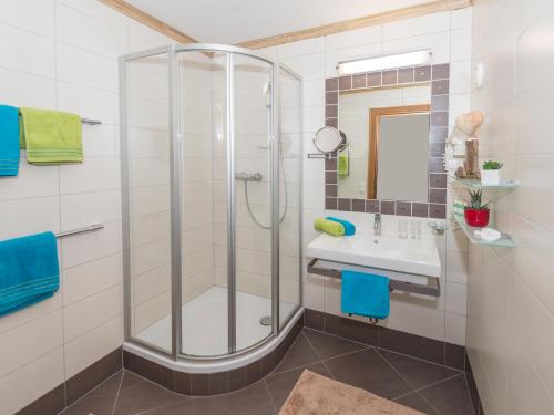 a bathroom with a shower and a sink at Appartementhaus Renate in Rauris