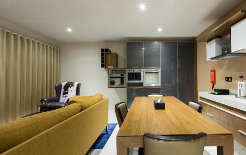a living room with a couch and a table at The Palms by Eagles in Takoradi