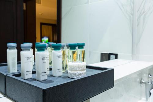 a shelf with several bottles of moisturizers in a bathroom at The Palms by Eagles in Takoradi