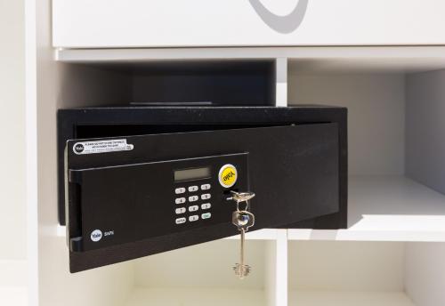 a microwave oven with a key in a drawer at The Palms by Eagles in Takoradi